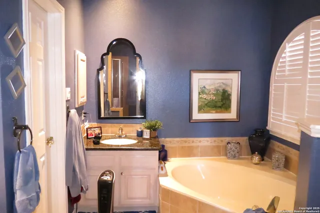 a bathroom with a tub and a sink