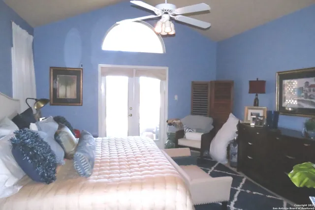 a bedroom with a bed mirror and window