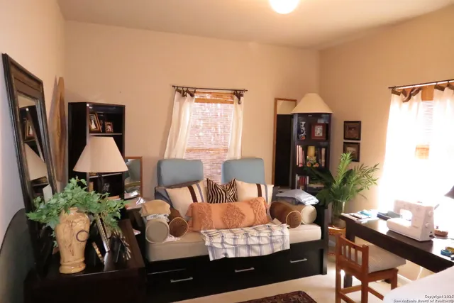 a living room with furniture and a lamp