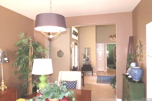 a front view of a house with wooden floor and a chandelier