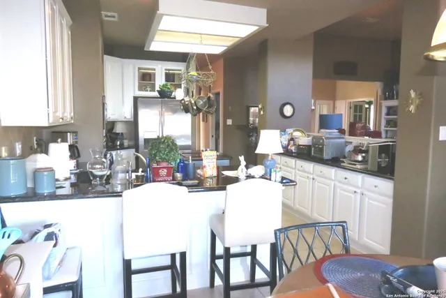 a dining room with granite countertop a couch and chairs