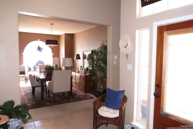 a living room with furniture and a mirror