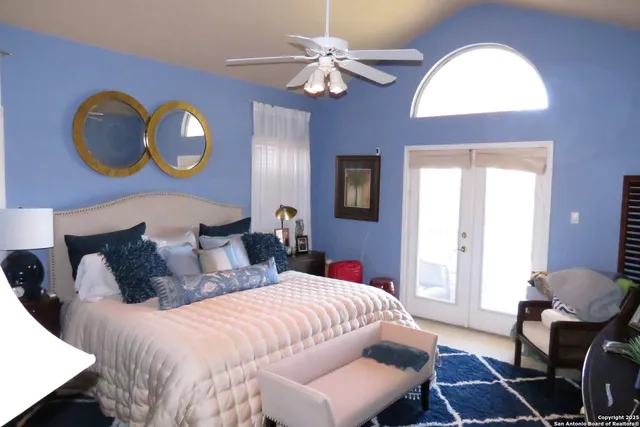 a bedroom with bed and a chandelier