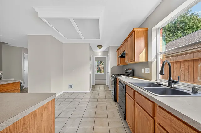 a kitchen with stainless steel appliances granite countertop a sink stove and cabinets