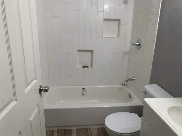 a white bath tub sitting next to a white toilet