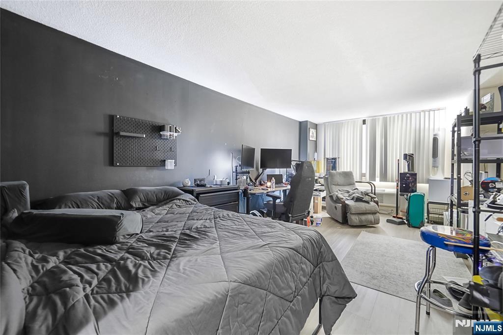 344 Prospect Avenue, Unit 4C Hackensack, NJ 07601 - Photo 13 of 19 a bedroom with furniture and a couch