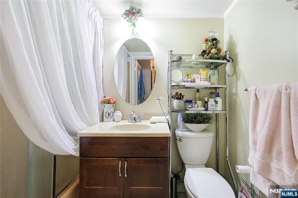 344 Prospect Avenue, Unit 4C Hackensack, NJ 07601 - Photo 14 of 19 a bathroom with a sink a toilet and a mirror