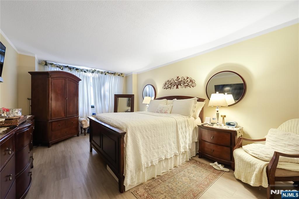 344 Prospect Avenue, Unit 4C Hackensack, NJ 07601 - Photo 15 of 19 a bedroom with a bed and a dresser