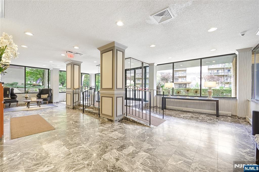 344 Prospect Avenue, Unit 4C Hackensack, NJ 07601 - Photo 3 of 19 a view of an empty room and floor to ceiling window