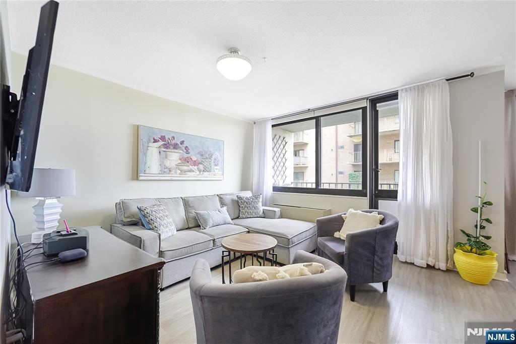 344 Prospect Avenue, Unit 4C Hackensack, NJ 07601 - Photo 9 of 19 a living room with furniture and wooden floor