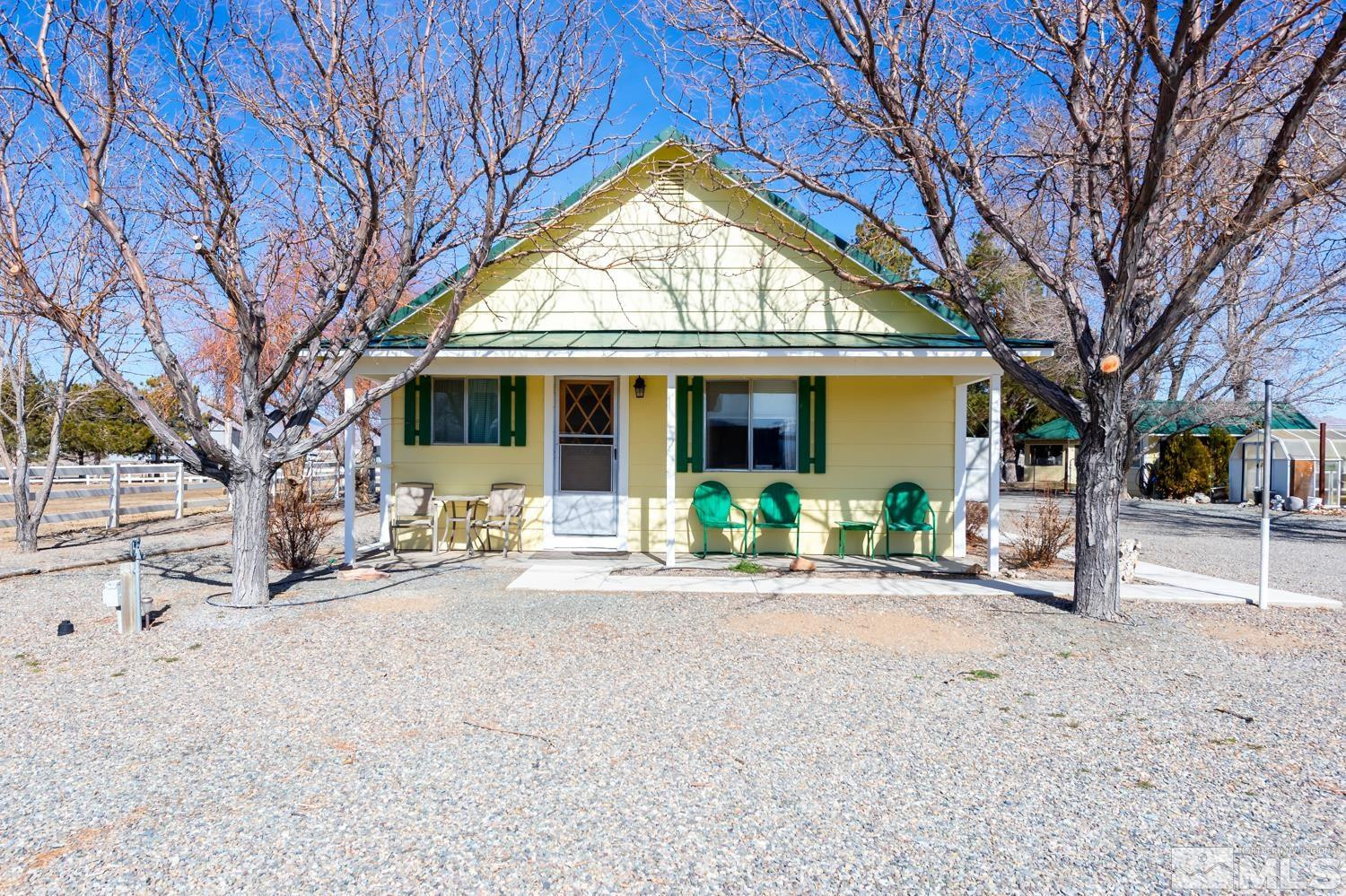 50 Miller Ridge Road Smith Valley, NV 89444 - Photo 13 of 51 a front view of a house with yard and a tree