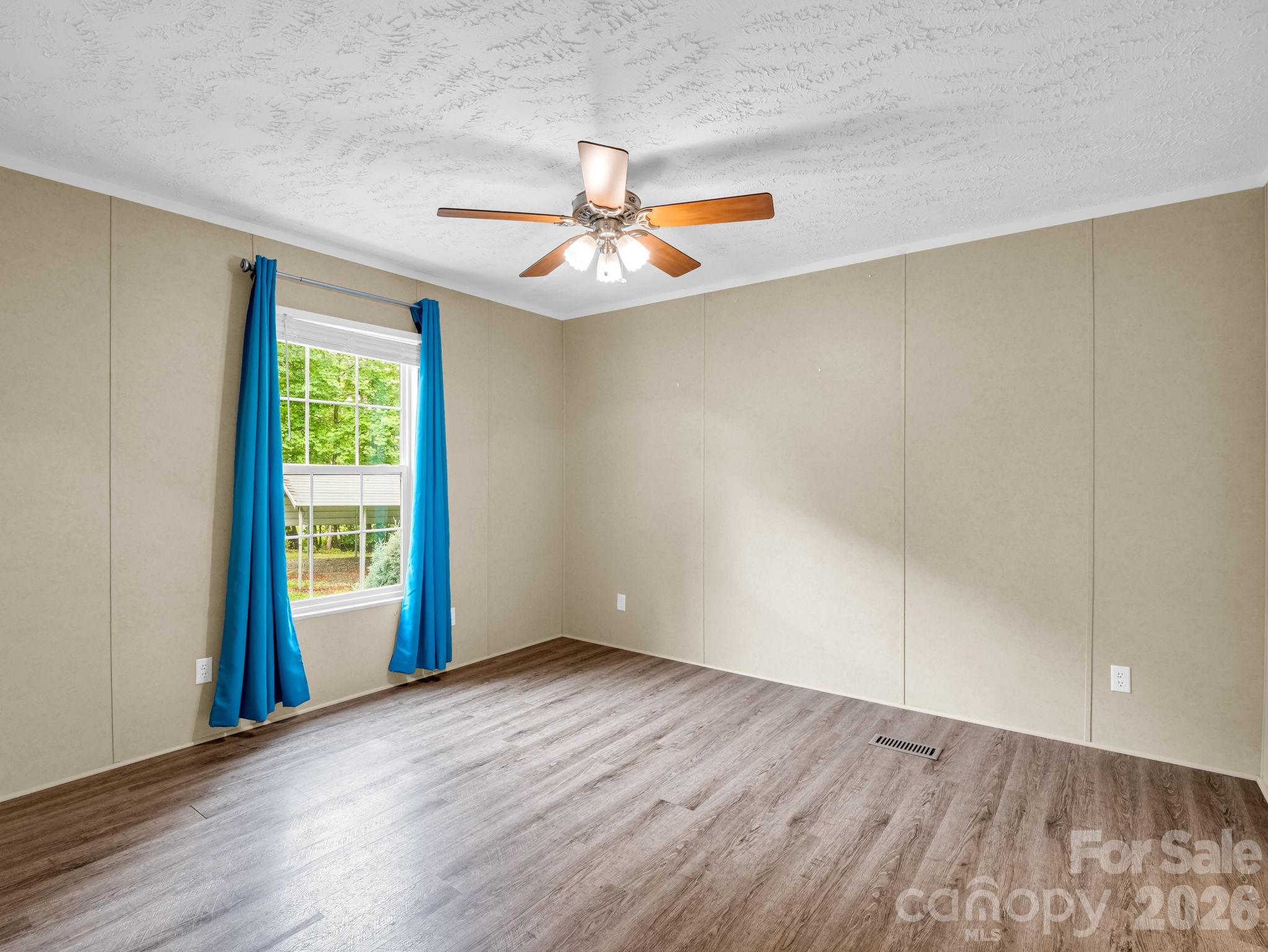 1449 Toney Road Bostic, NC 28018 - Photo 28 of 43 an empty room with wooden floor fan and windows