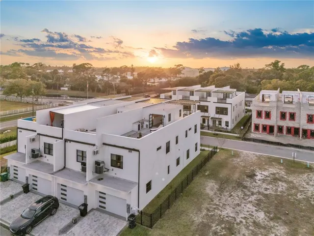 an aerial view of a house with wooden fence