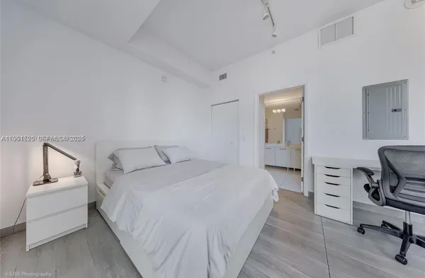 a bed room with a bed and furniture