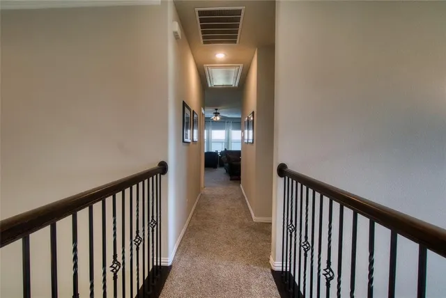 a view of a hallway view with wooden floor and staircase