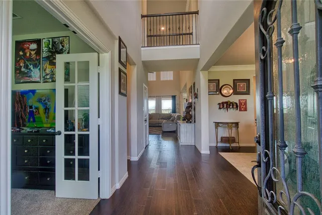 a view of a hallway with wooden floor
