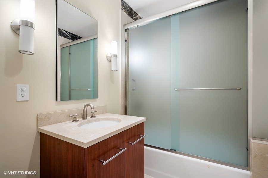 401 North Wabash Avenue, Unit 86D Chicago, IL 60611 - Photo 14 of 42 a bathroom with a sink vanity and a mirror