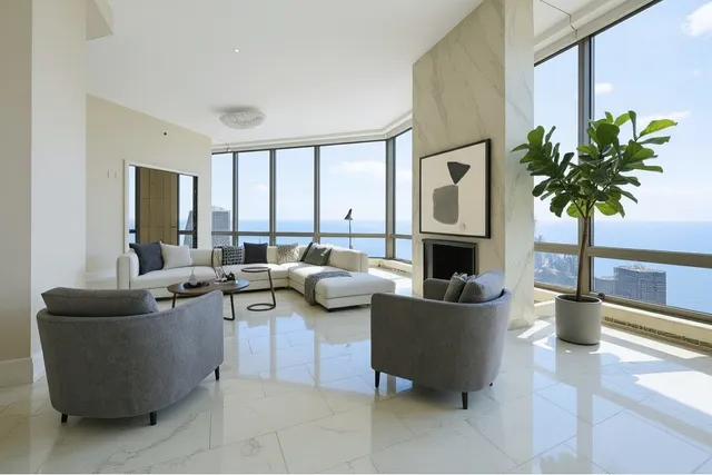 a living room with fireplace furniture and a large window