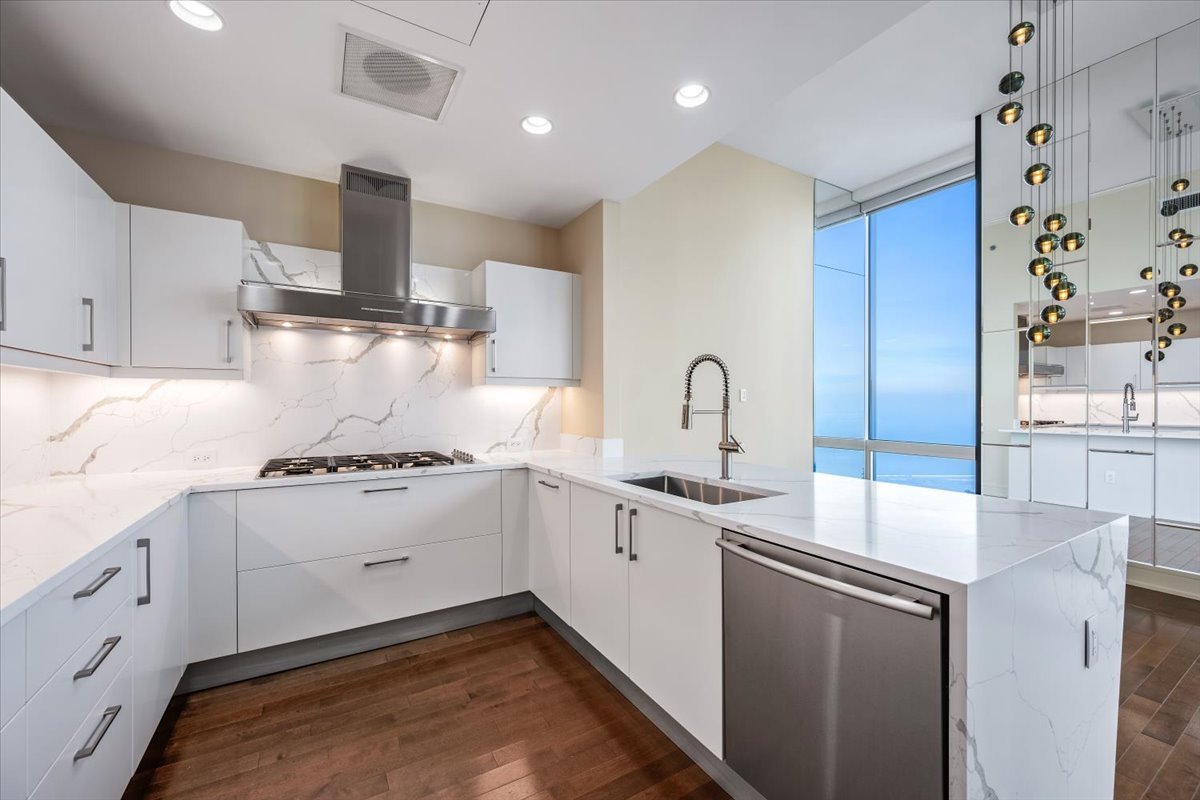 401 North Wabash Avenue, Unit 86D Chicago, IL 60611 - Photo 6 of 50 a kitchen with a sink stove and cabinets