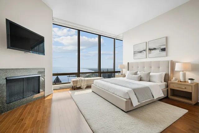 a bedroom with a large bed and a flat screen tv