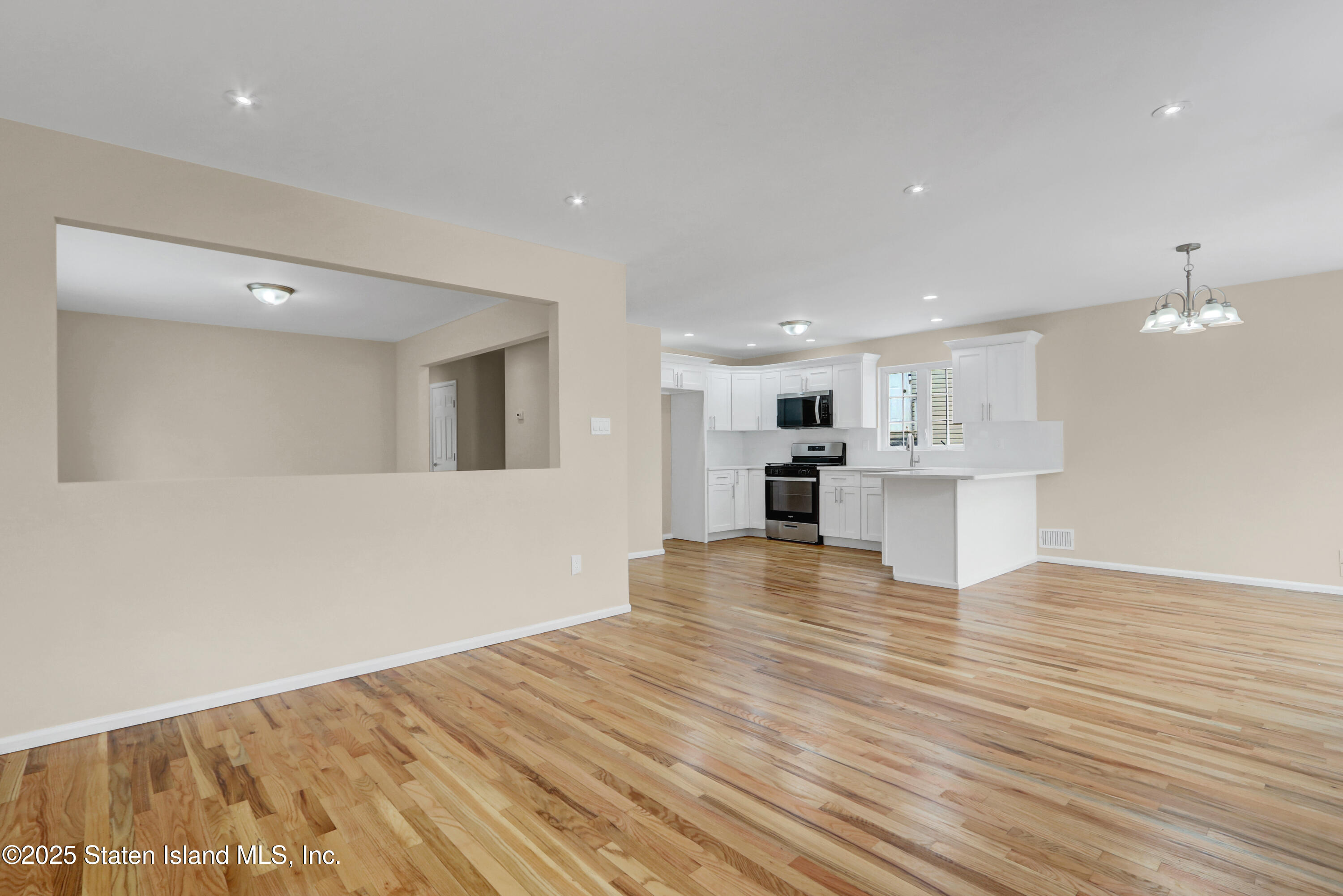 103 Savo Loop Staten Island, NY 10309 - Photo 17 of 46 a view of kitchen dining table chairs microwave and cabinets