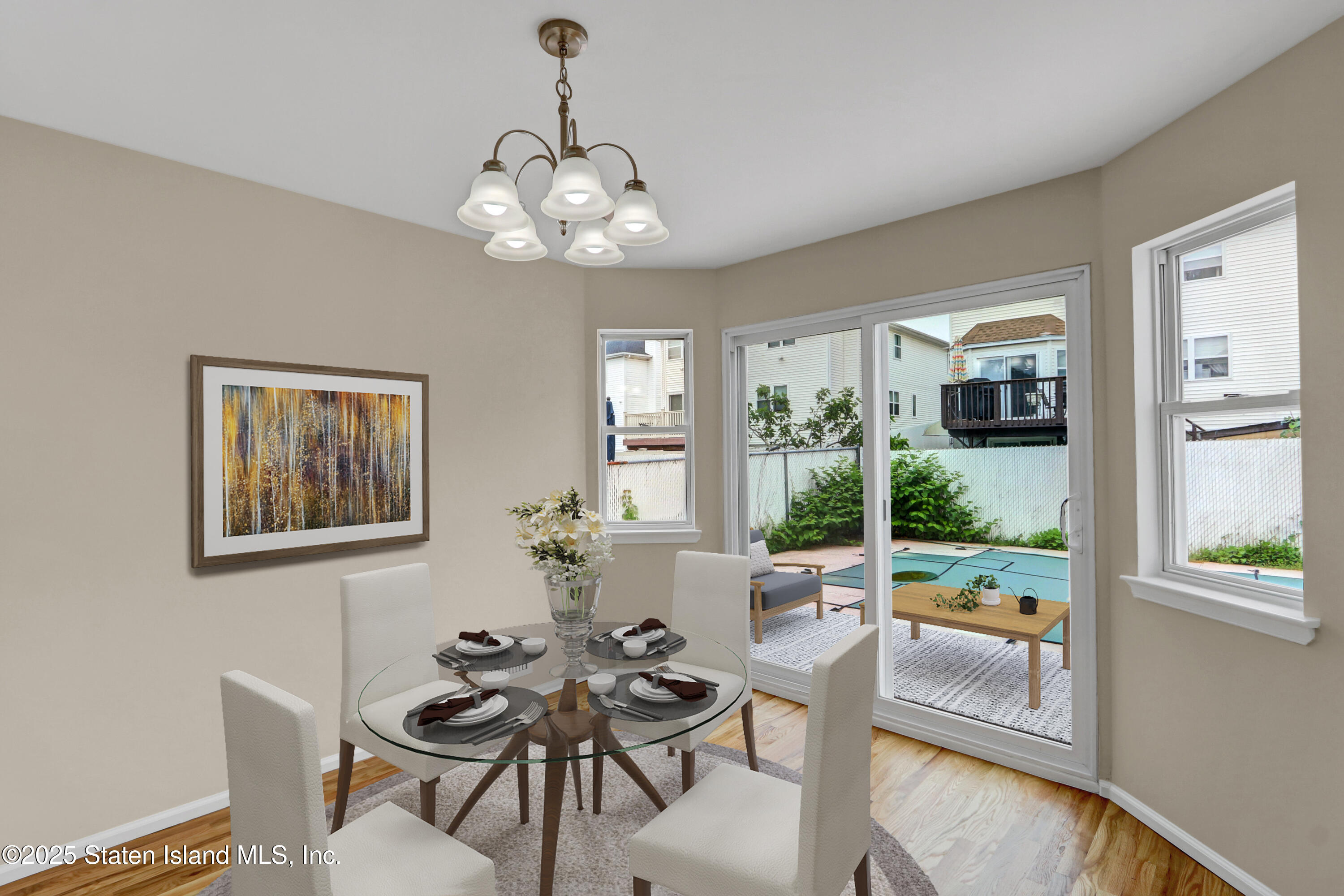 103 Savo Loop Staten Island, NY 10309 - Photo 18 of 46 a view of a dining room with furniture a livingroom and chandelier