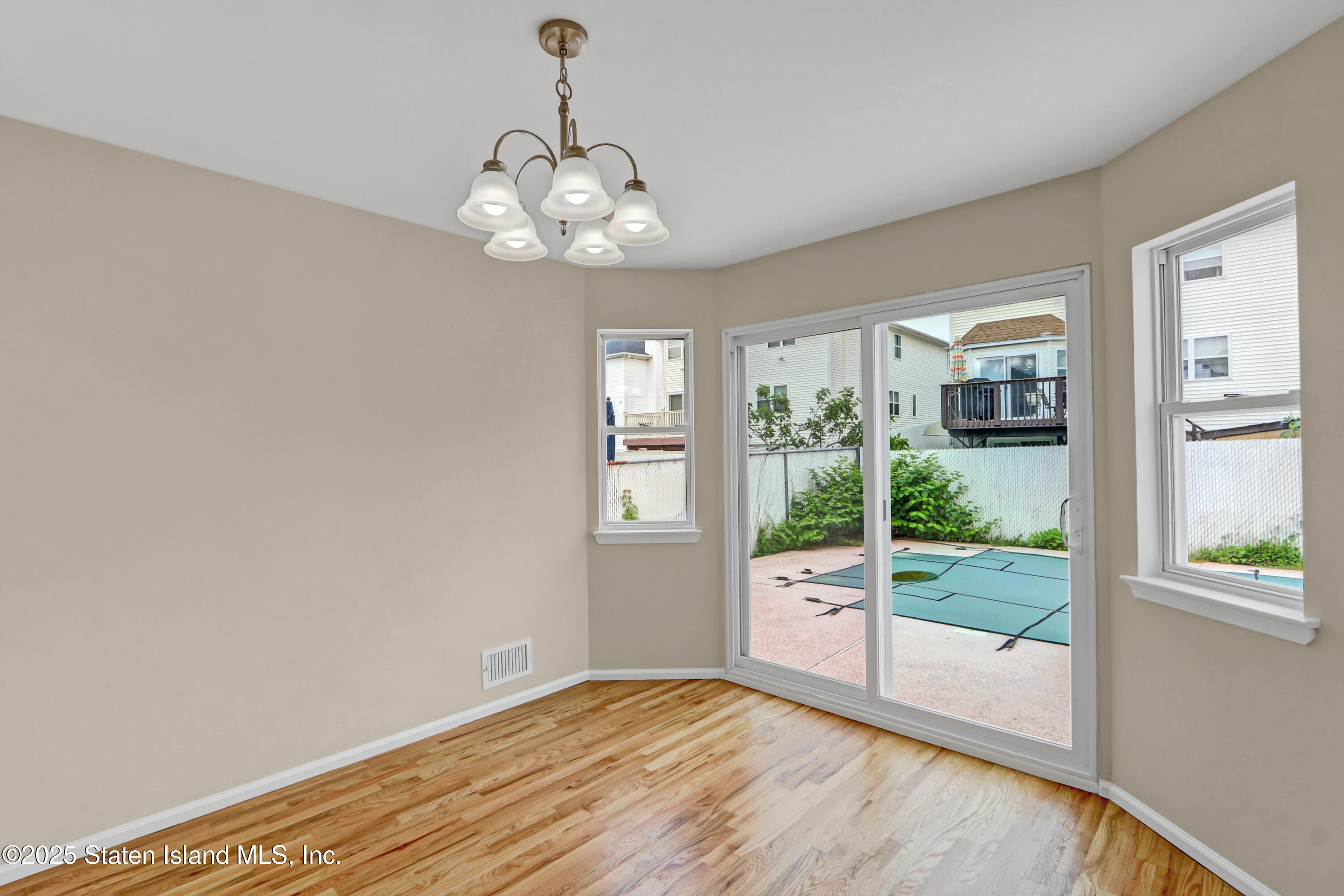103 Savo Loop Staten Island, NY 10309 - Photo 19 of 46 a view of an empty room with wooden floor and outdoor view