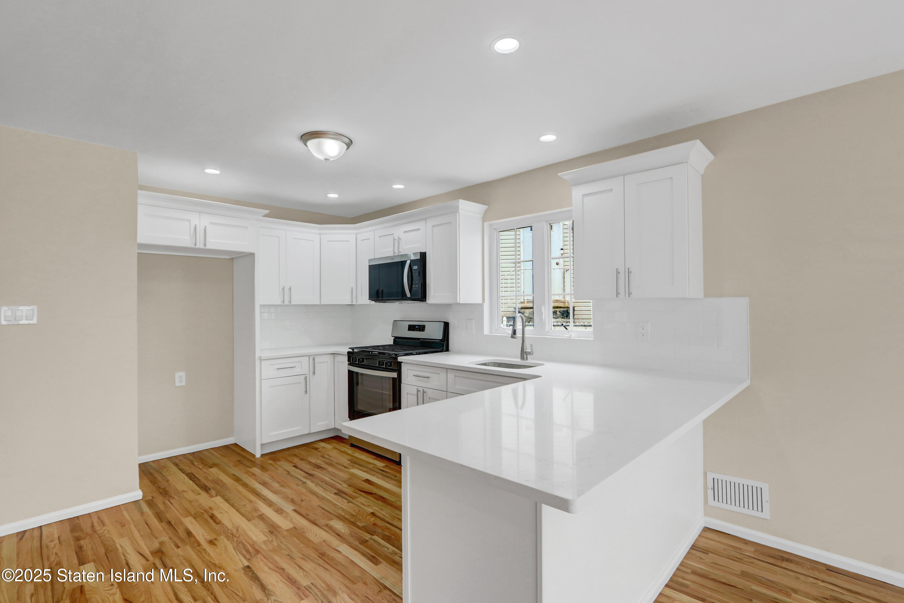 103 Savo Loop Staten Island, NY 10309 - Photo 20 of 46 a kitchen with granite countertop a sink stainless steel appliances and white cabinets