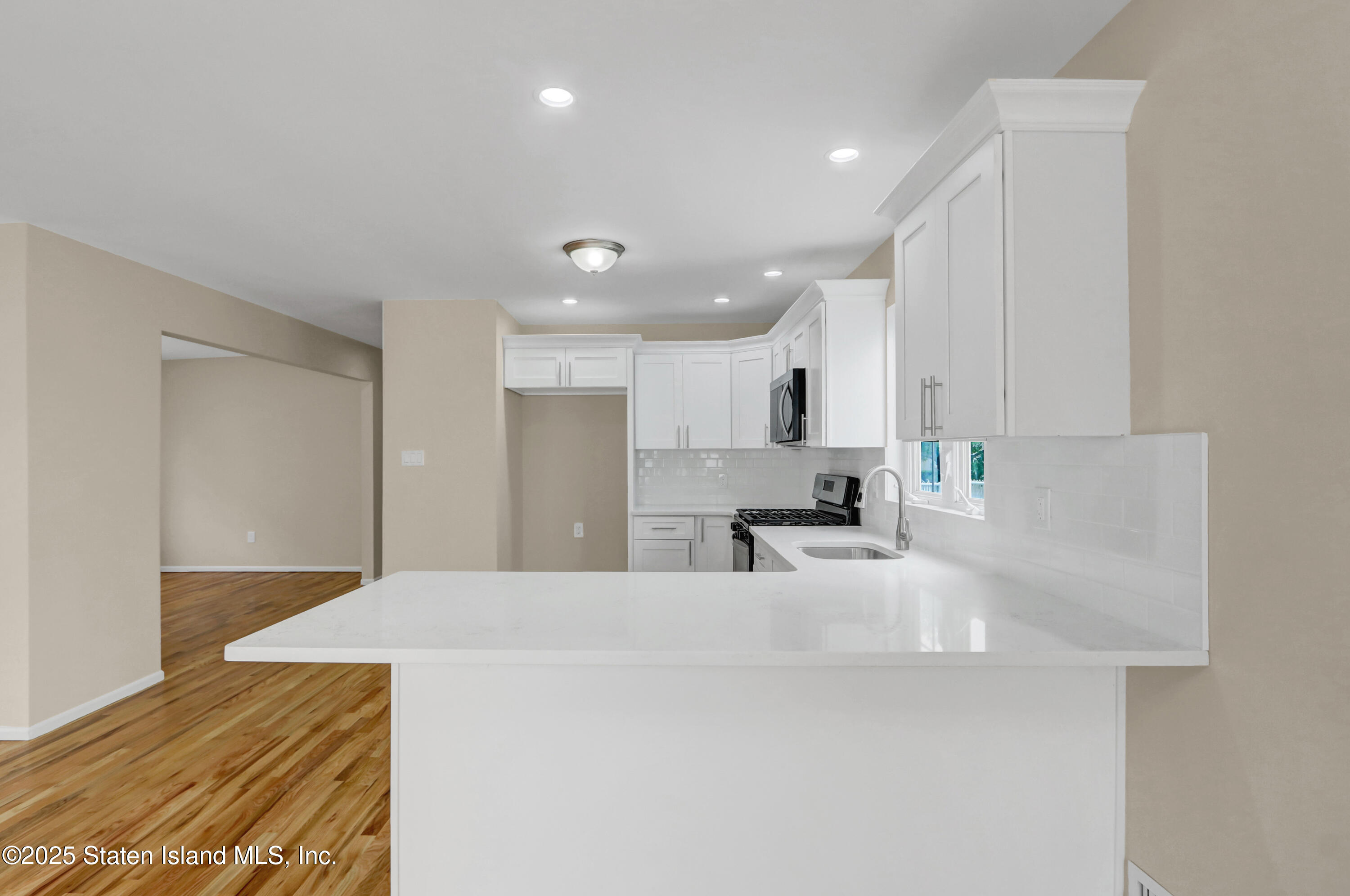 103 Savo Loop Staten Island, NY 10309 - Photo 22 of 46 a large white kitchen with kitchen island a sink stainless steel appliances and cabinets