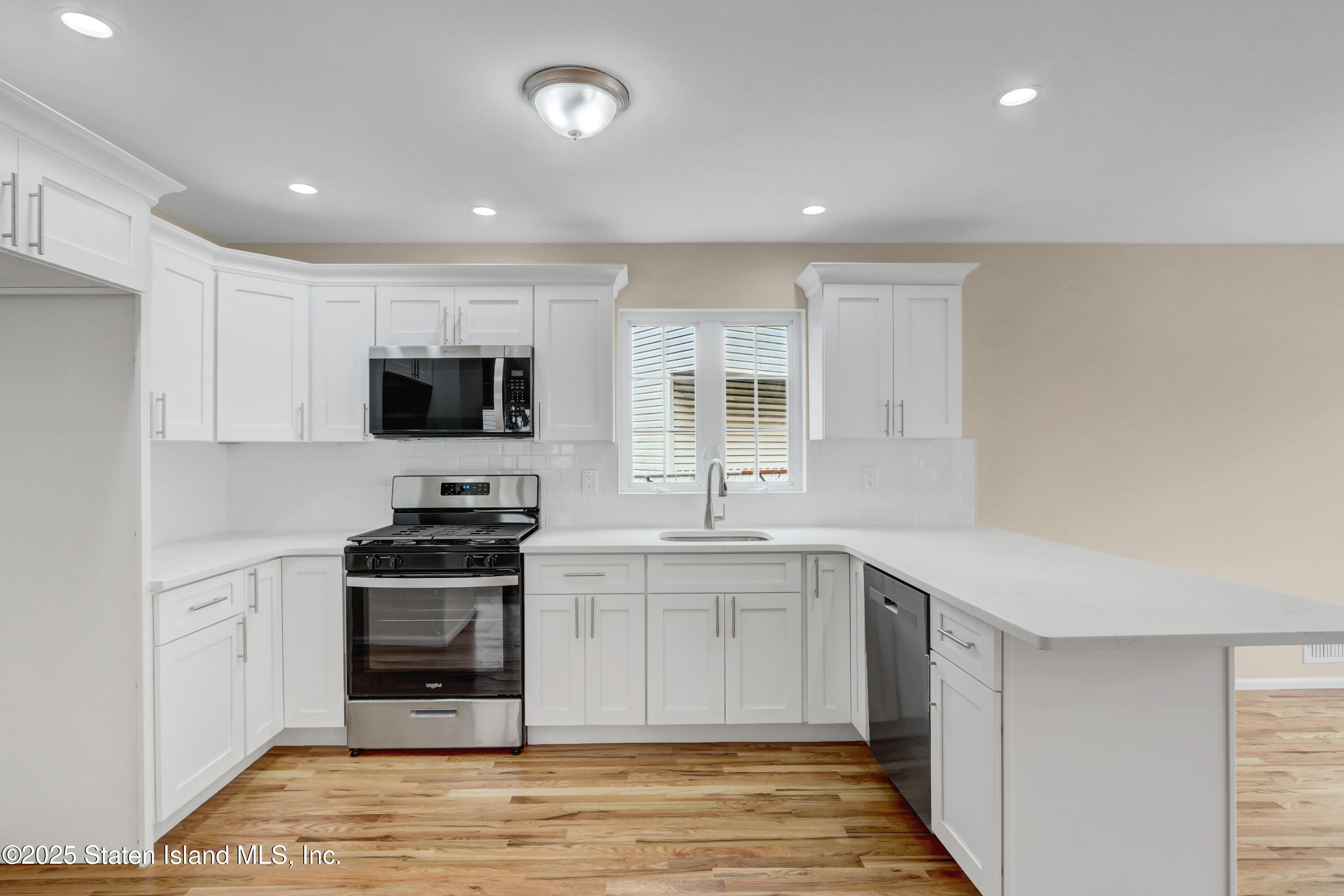 103 Savo Loop Staten Island, NY 10309 - Photo 23 of 46 a kitchen with stainless steel appliances a stove sink microwave and cabinets