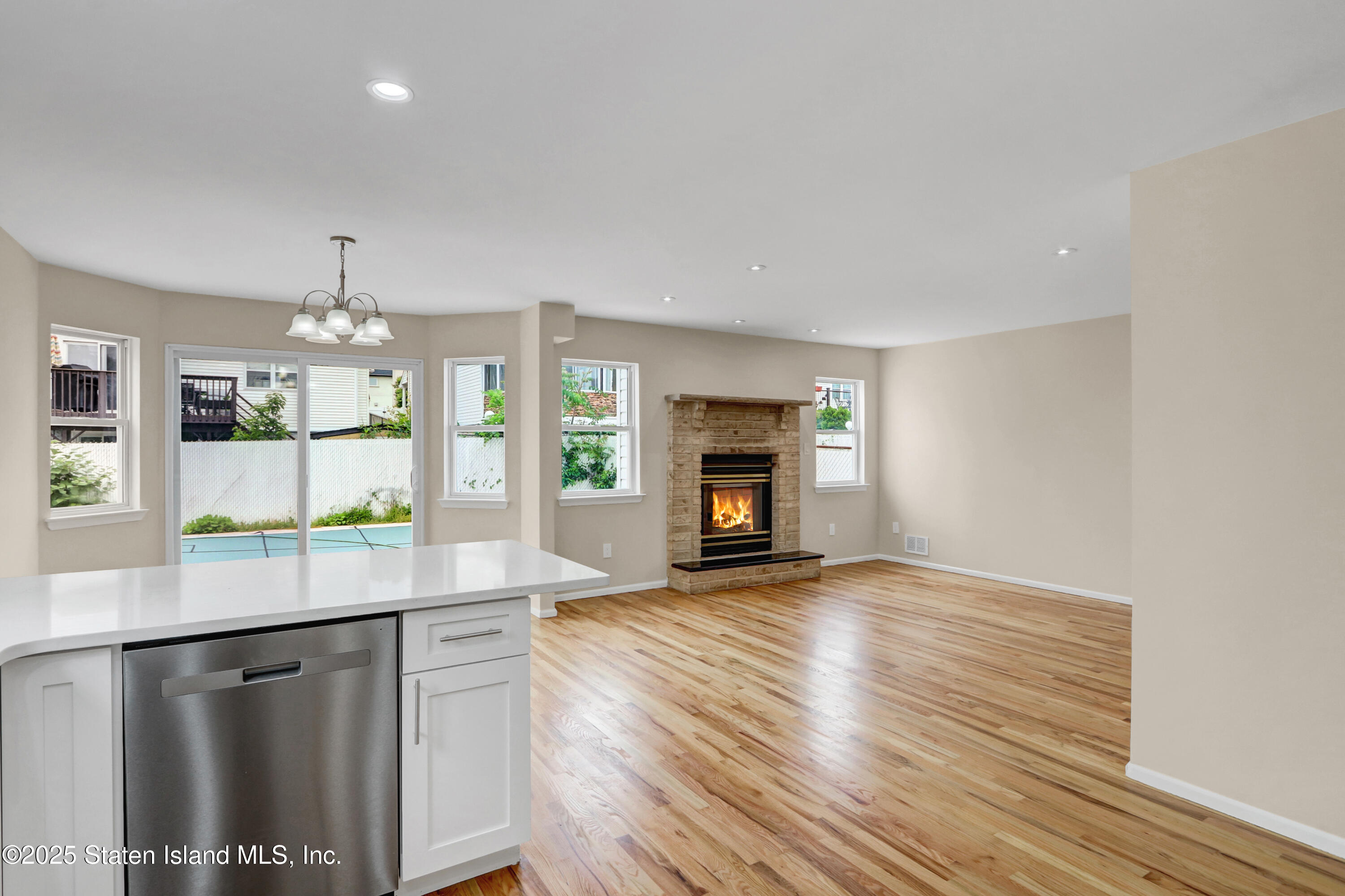 103 Savo Loop Staten Island, NY 10309 - Photo 24 of 46 a kitchen with granite countertop wooden floors and a fireplace