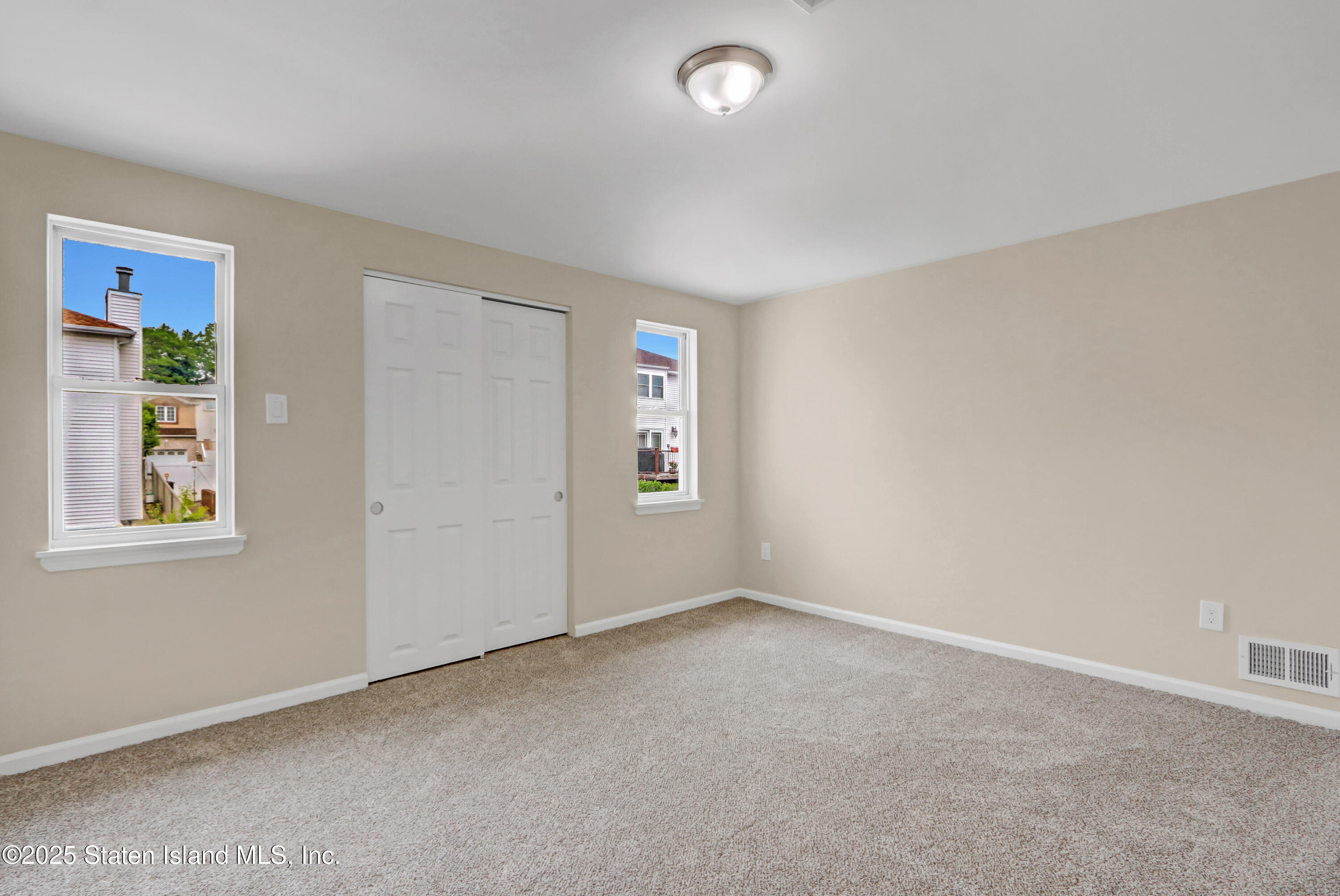 103 Savo Loop Staten Island, NY 10309 - Photo 29 of 46 an empty room with windows