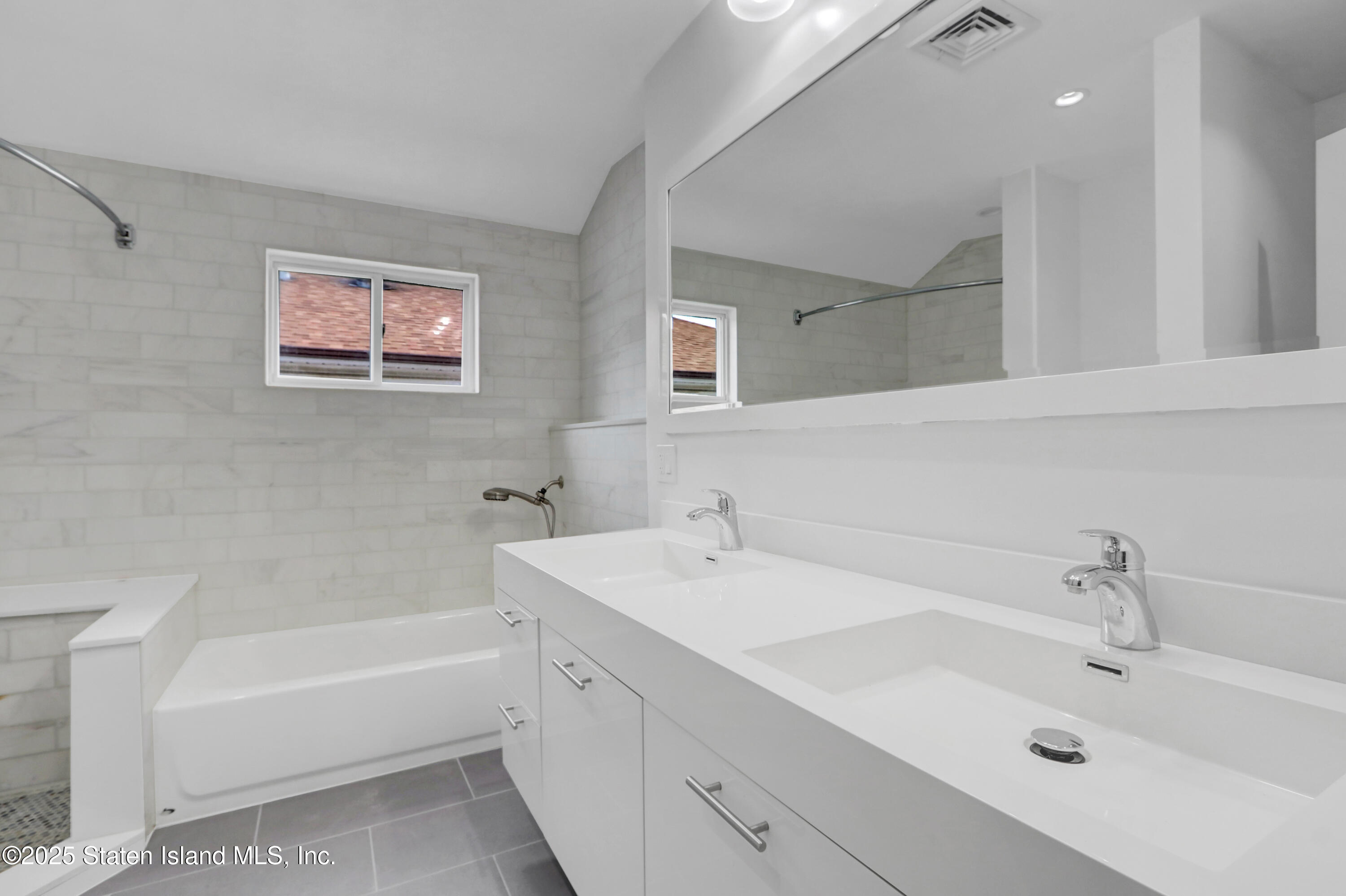 103 Savo Loop Staten Island, NY 10309 - Photo 32 of 46 a bathroom with a tub a sink and mirror