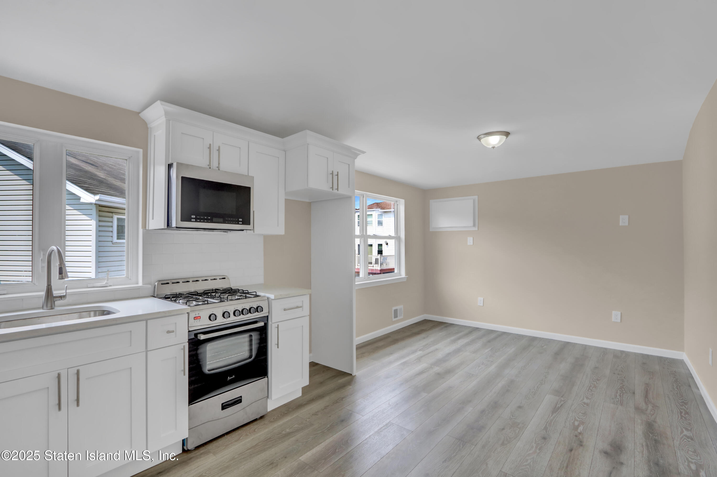 103 Savo Loop Staten Island, NY 10309 - Photo 38 of 46 a kitchen with stainless steel appliances white cabinets and stove top oven