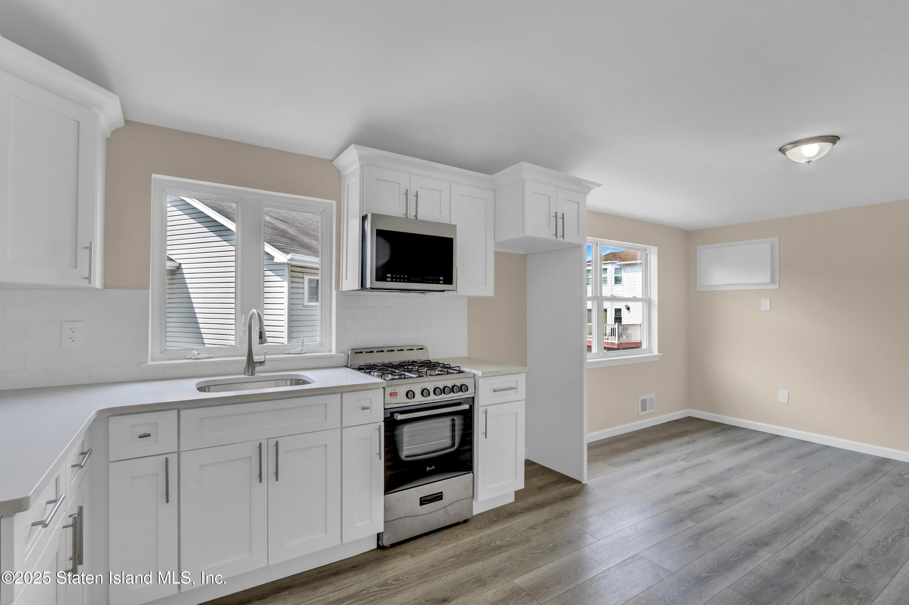 103 Savo Loop Staten Island, NY 10309 - Photo 40 of 46 a kitchen with stainless steel appliances white cabinets and a window