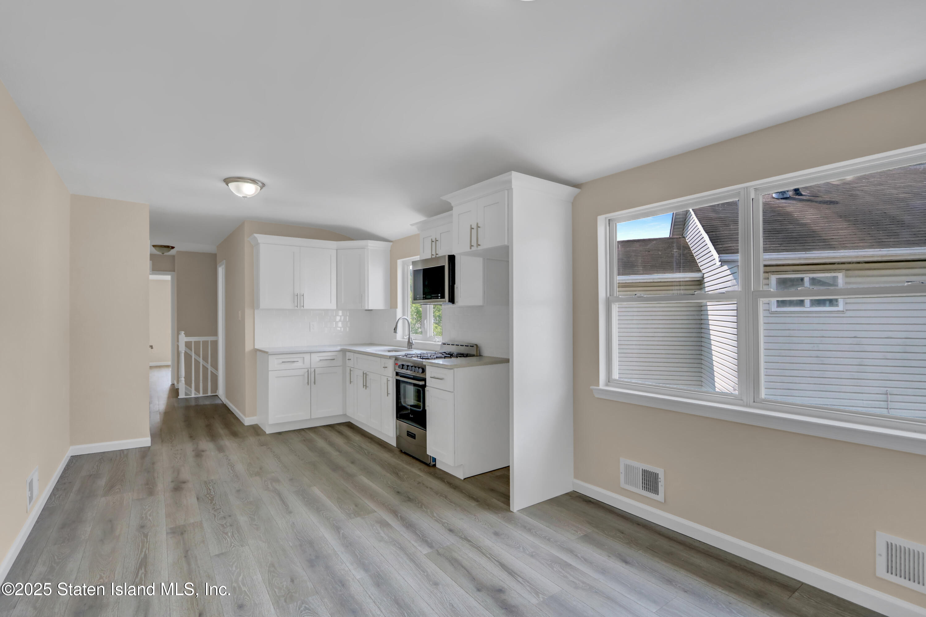 103 Savo Loop Staten Island, NY 10309 - Photo 41 of 46 a kitchen with a refrigerator and white cabinets
