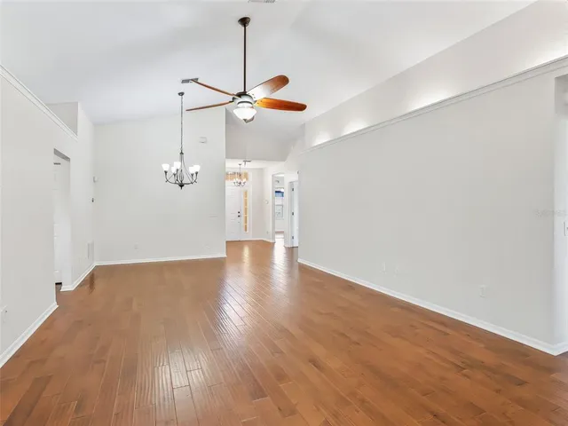 a living room with furniture a flat screen tv and a dining table