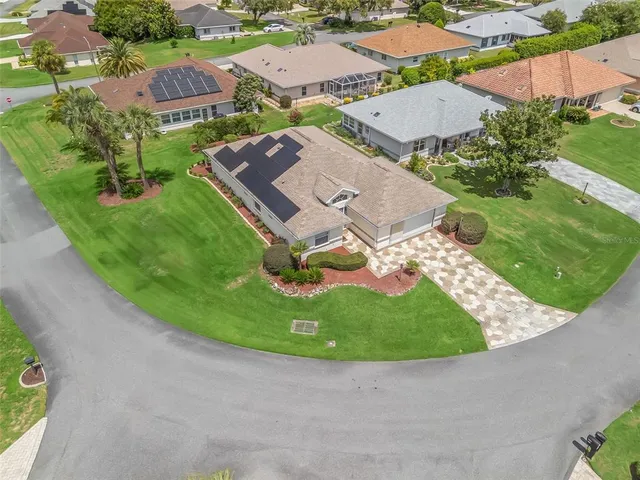 an aerial view of residential houses with outdoor space and street view