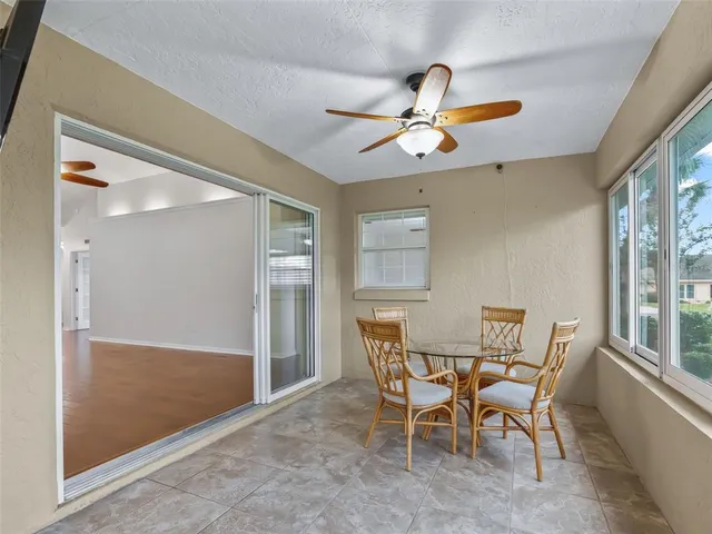 a view of a house with a yard and potted plants