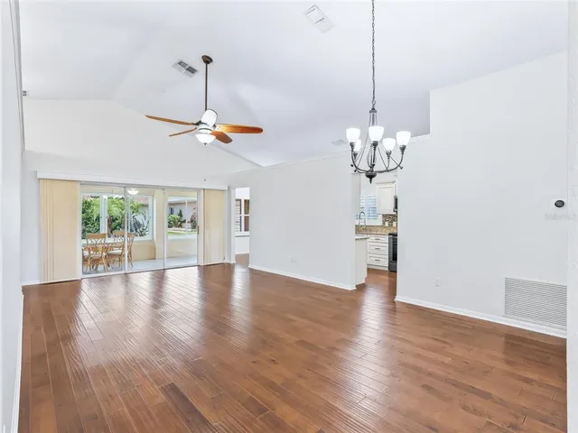 a view of a room with wooden floor chandelier and closet