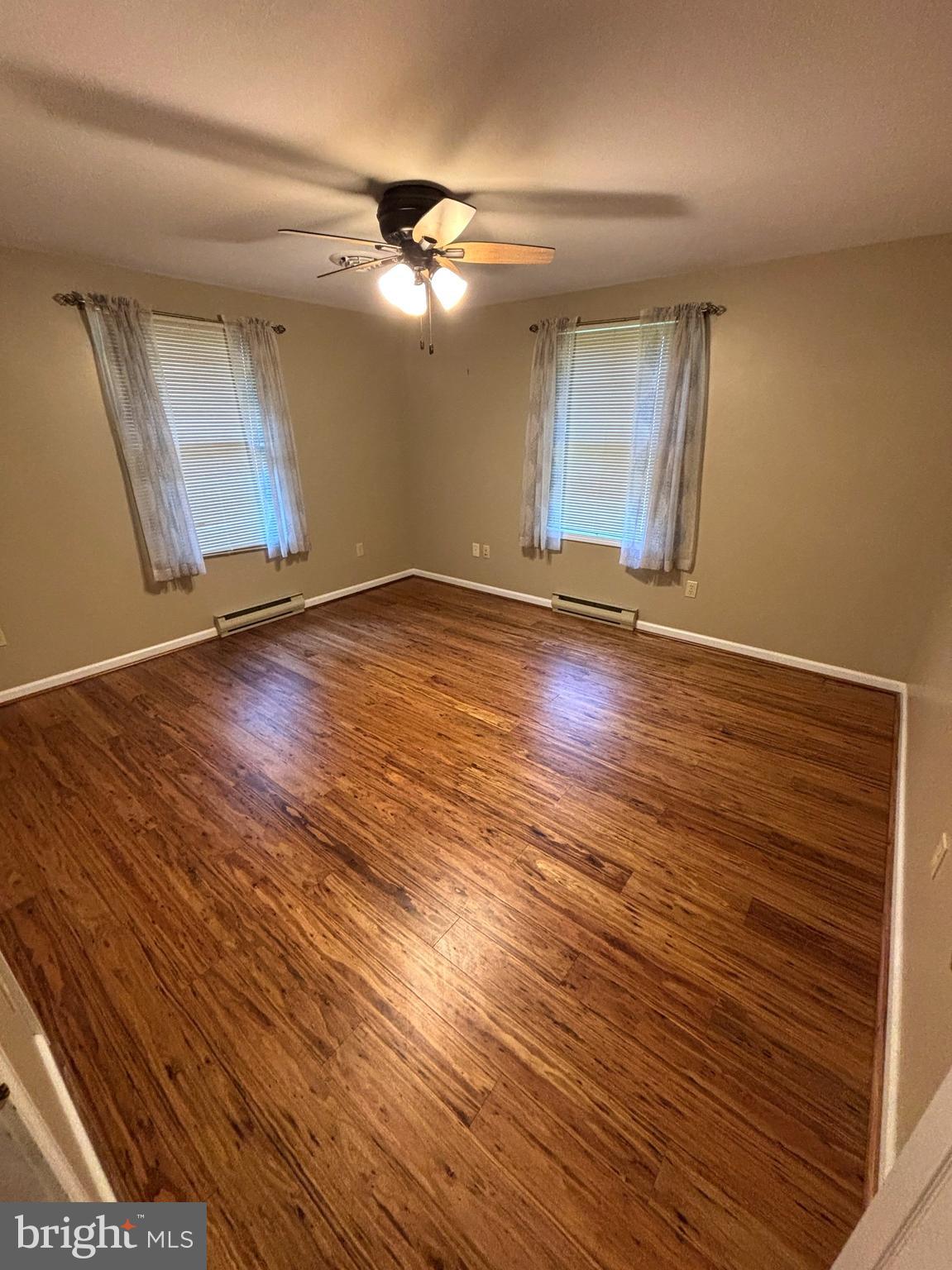 2080 Pumping Station Road Fairfield, PA 17320 - Photo 54 of 137 an empty room with wooden floor chandelier fan and windows