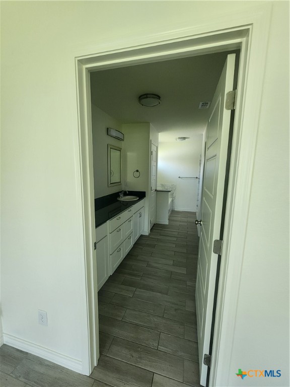 907 East 3rd Street, Unit B Lampasas, TX 76550 - Photo 15 of 19 a view of a bathroom from a hallway