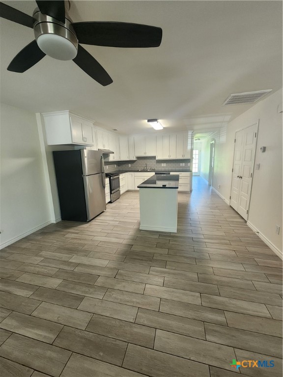 907 East 3rd Street, Unit B Lampasas, TX 76550 - Photo 3 of 19 a view of a kitchen with kitchen island a counter top space a sink and stainless steel appliances