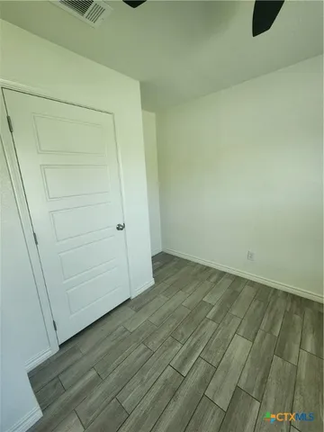an empty room with wooden floor