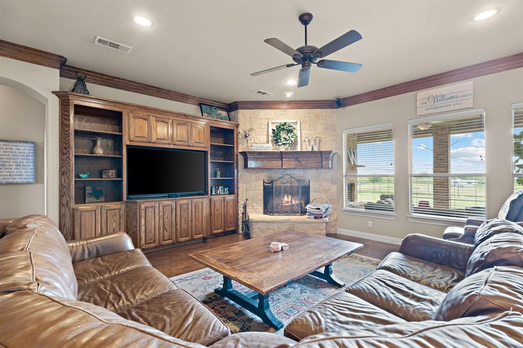 1341 Maxwell Road Haslet, TX 76052 - Photo 14 of 40 a living room with furniture a flat screen tv and a large window