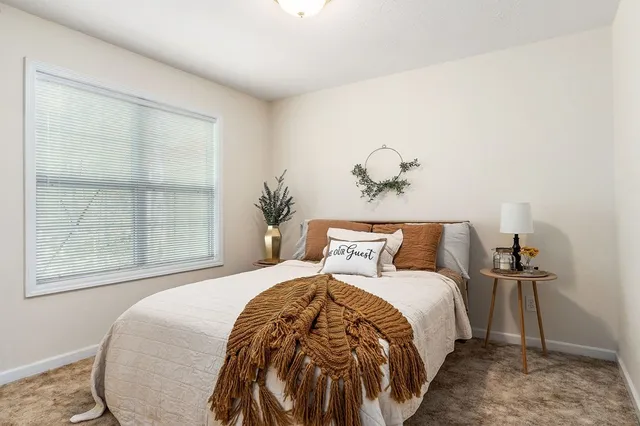 a bedroom with a large bed and a window