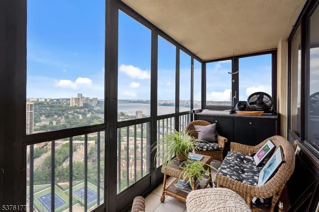 a living room filled with furniture and a floor to ceiling window