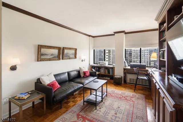 a bathroom with a granite countertop sink a mirror and a toilet