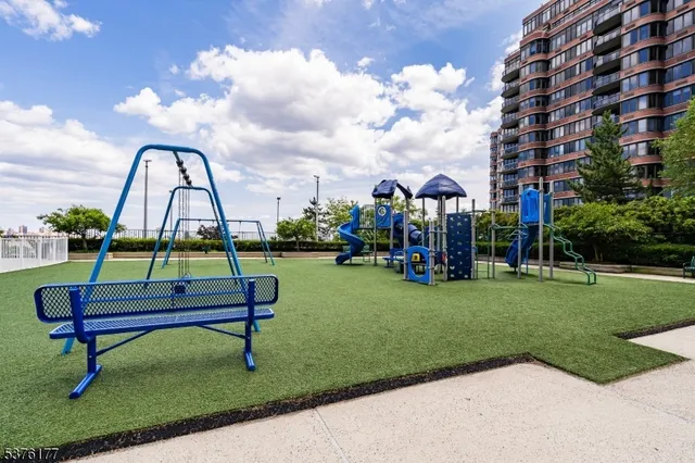a view of garden with patio area and swimming pool