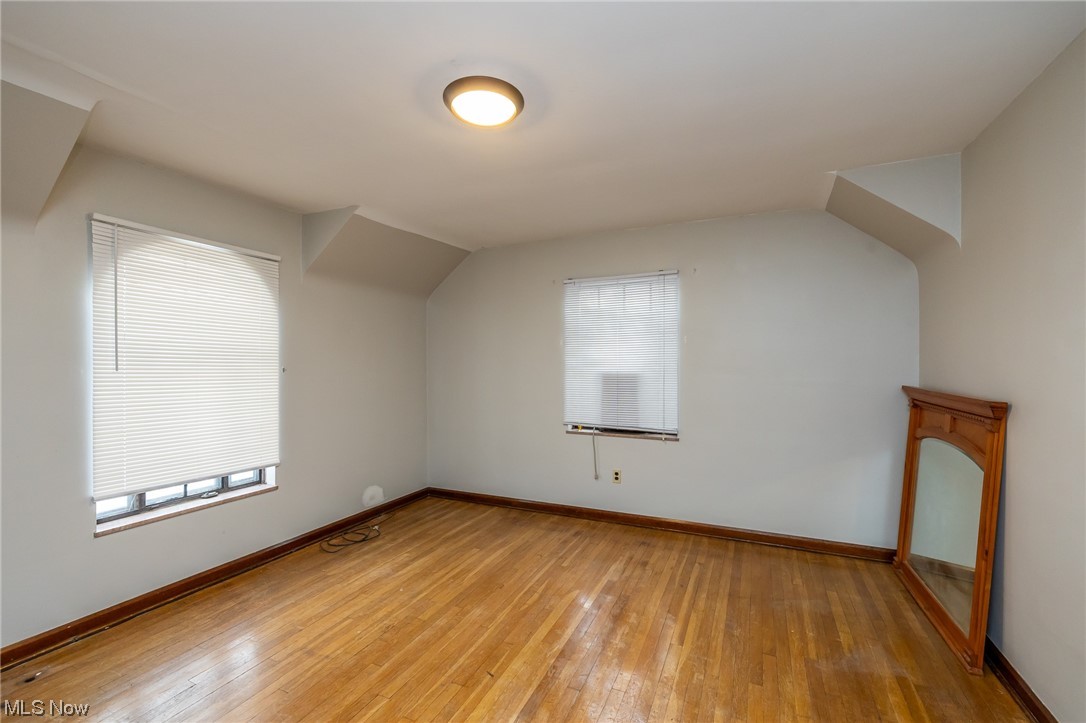 4668 Broadale Road Cleveland, OH 44109 - Photo 22 of 25 Additional living space with light wood-type flooring and vaulted ceiling
